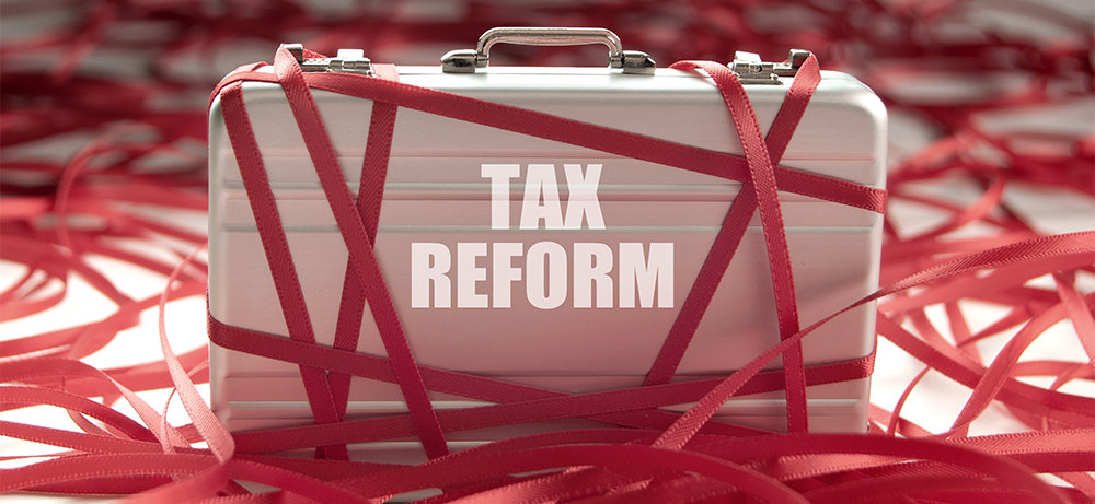 Tax reform briefcase with red tape